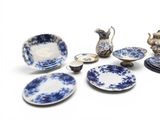 several pieces of blue and white pottery sitting on top of a table