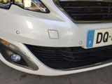 a white car parked in a parking lot with a number plate on the front