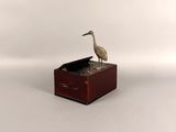 a bird that is sitting on top of a box
