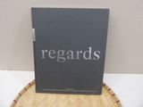 the book is sitting on top of a wicker chair