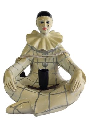 a figurine of a woman sitting on the ground with a cup in her hand