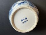 a blue and white vase sitting on a table