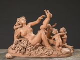 statue of a group of nudes sitting on a rock