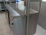 a large stainless steel counter in a kitchen