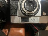 a silver camera sitting on top of a brown box