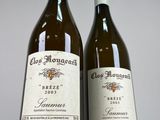 two bottles of wine sitting next to each other on a table