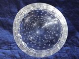 an image of a clear glass bowl sitting on top of a blue cloth