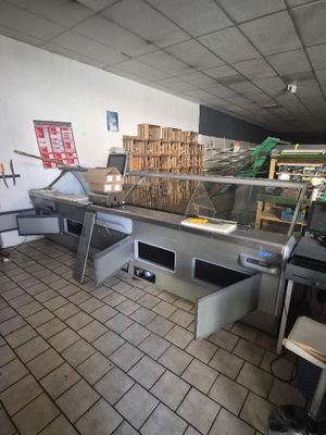 an image of a restaurant kitchen with a lot of food on the counter
