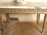 a marble table with a lamp on top of it