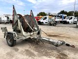 a trailer with a hose attached to it in a parking lot
