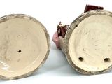 pair of brown and white ceramic vases on a white surface
