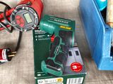 a box of tools sitting on a table next to a blue box