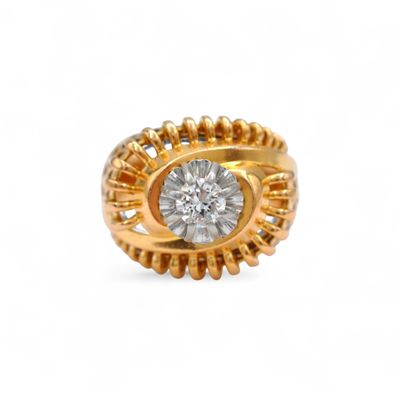 a close up of a gold and diamond ring on a white background