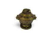 brass plated urn with lion heads on top of it