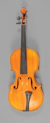 an old violin with a bow on a gray background