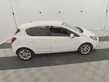 a picture of a small white car parked in a garage