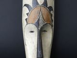 an image of a wooden mask on a black background