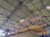 a large amount of wood stacked on top of each other in a building