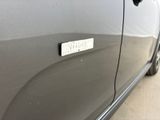 a close up of a car door with a sticker on it