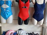 three mannequins in a room with various types of swimsuits on display