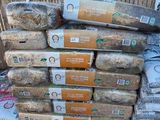 a pile of bread sitting on top of a pile of bags