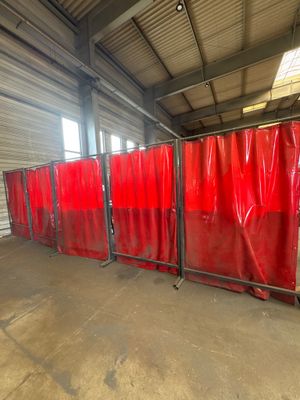 a group of red privacy screens in a warehouse