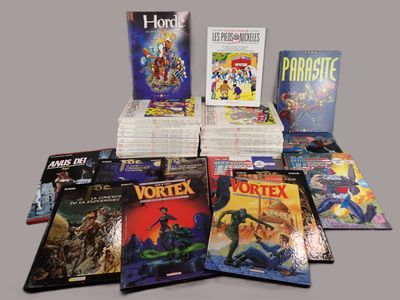 a lot of comic books that are on the table