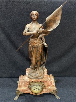 une image représentant une statue de femme tenant un drapeau et une horloge
