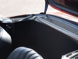 a close up of a red convertible car with the door open