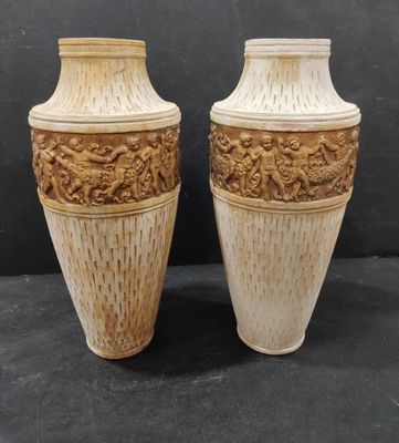 two vases that are sitting on a black surface
