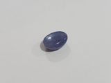 a blue sapphire stone on a white surface