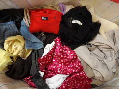 une pile de vêtements posée sur un lit