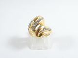 a close up of a gold and diamond ring on a white surface