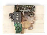 a picture of a man ' s head made out of electronic components