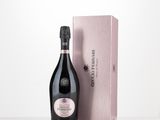 the bottle of champagne is next to the box on the table