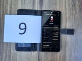 an image of a cell phone sitting next to a notepad on a wooden table