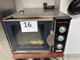 a microwave sitting on top of a table with a price tag on it