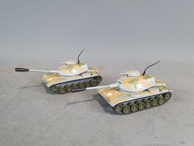 two toy tanks sitting side by side on the floor