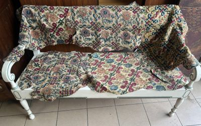 a white bench with a floral seat cover on it
