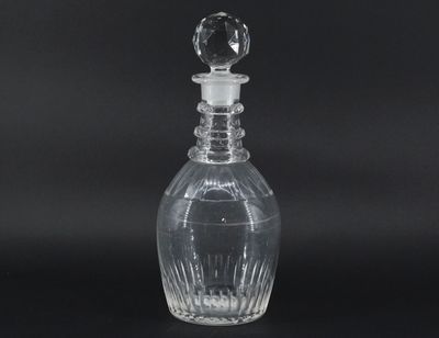 clear glass decanter with a clear stopper on a black background