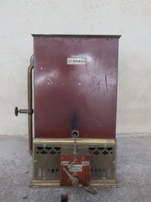 a small red machine that is sitting on the ground