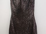 a black and silver dress hanging on a hanger