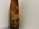 a brown vase sitting on top of a white shelf