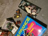 a lot of books and games on the floor