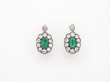 a pair of emerald and diamond earrings