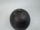 a black object on a white surface with a white background