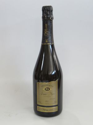 an old bottle of champagne sitting on a white surface