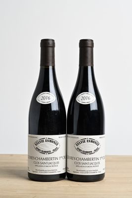 two bottles of wine sitting on top of a table next to each other