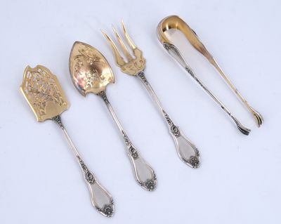 three silver spoons and a fork are sitting next to each other