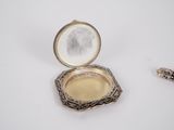 a small silver box with a mirror in it